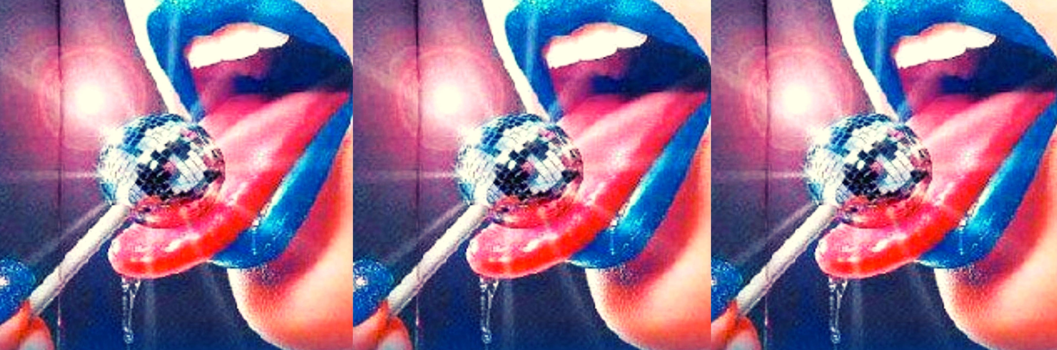 woman with blue lipstick licking glitterball lolipop