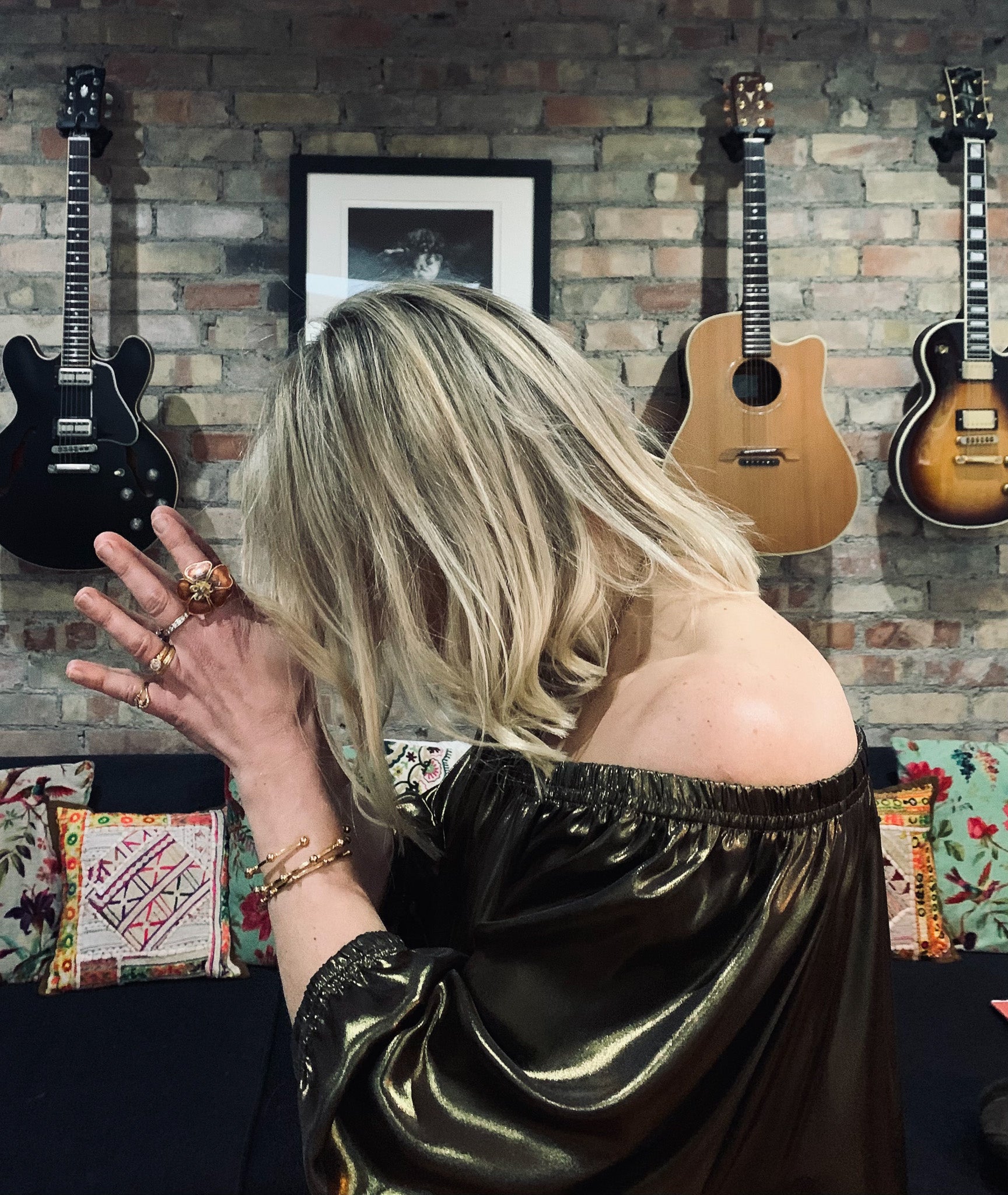 Rebecca wearing Ausus metallic gold maxi dress with hands in prayer at 3rd eye