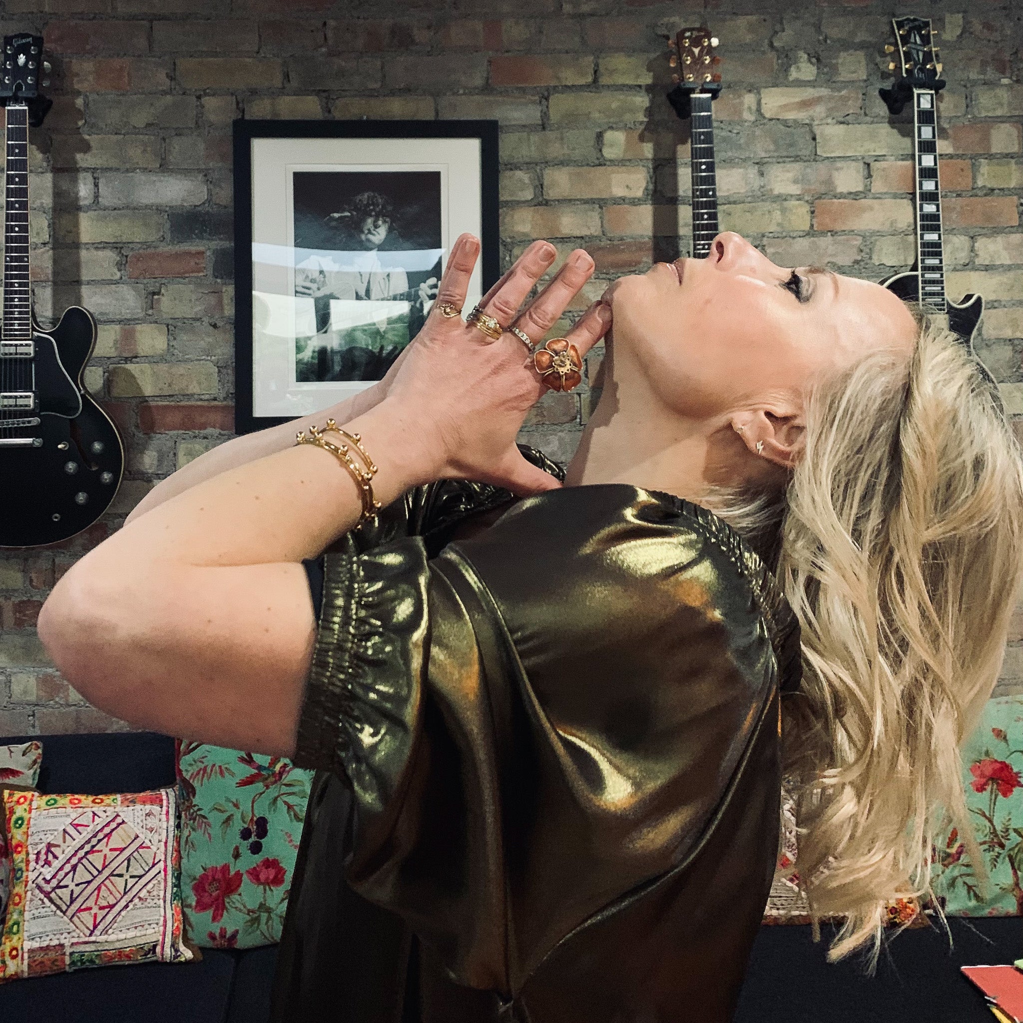 Rebecca in ausus metallic gold maxi dress with hands in prayer at throat