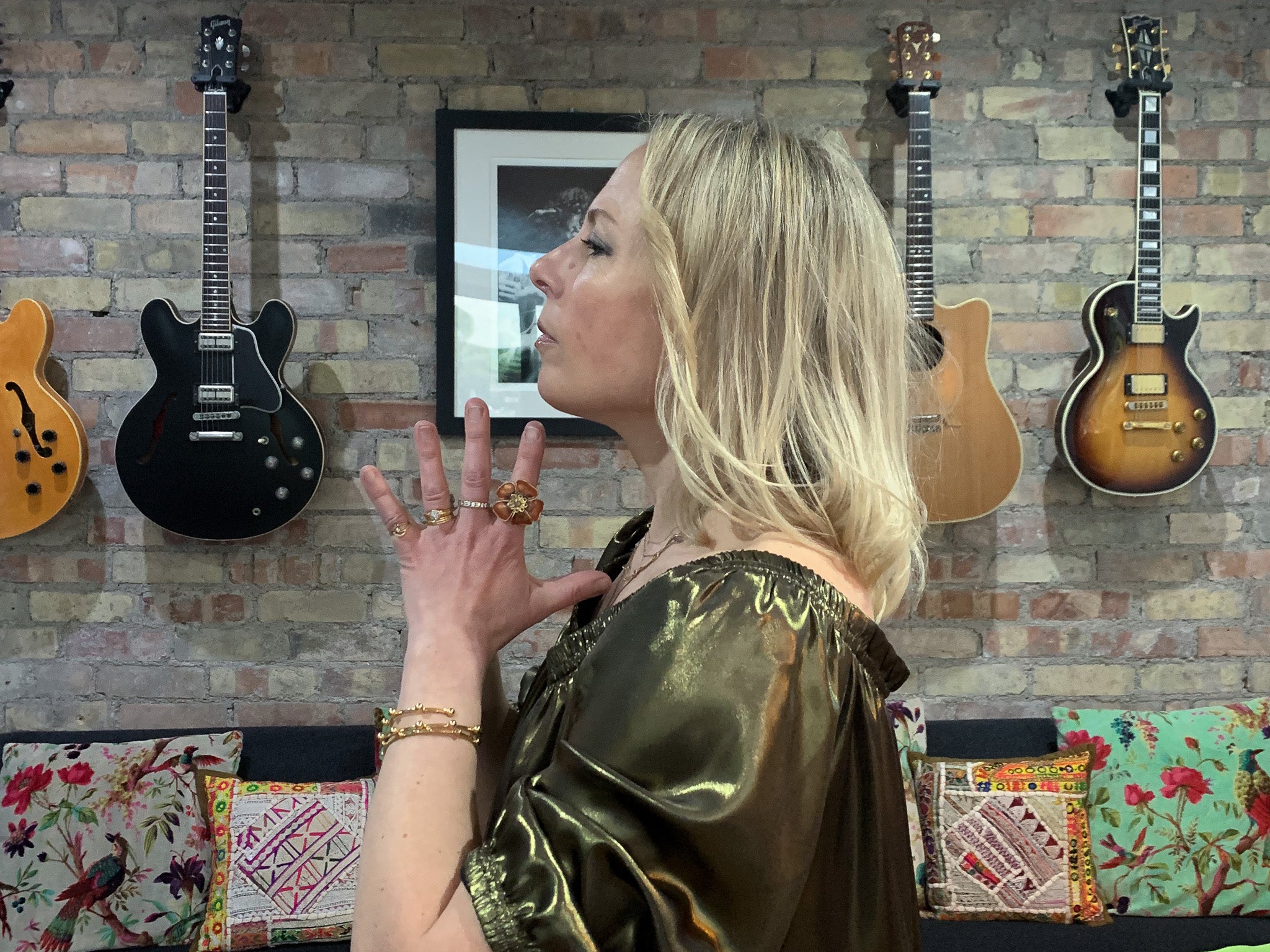 Rebecca in ausus metallic gold maxi dress with hands in prayer at heart