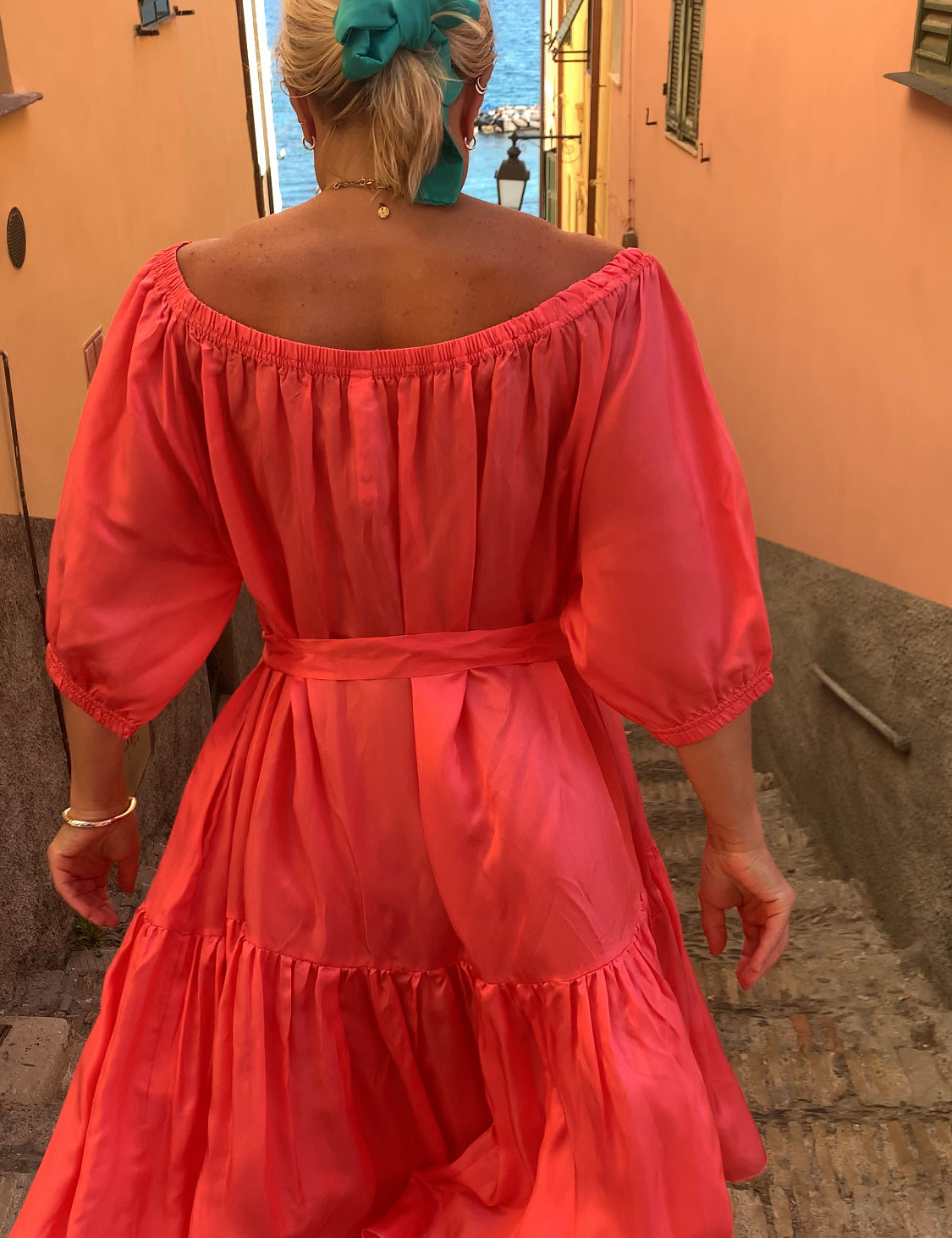 Woman in Ausus maxi dress spritz orange in Liguria Italy