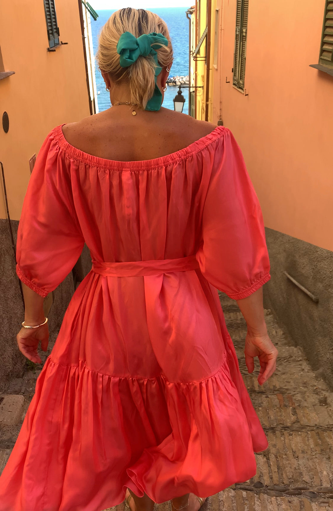 Woman in Ausus maxi dress spritz orange in Liguria Italy