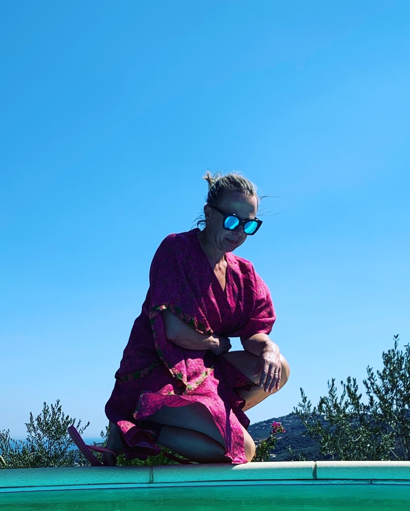 Rebecca kneeling by pool wearing neem vintage silk sari kimono wrap