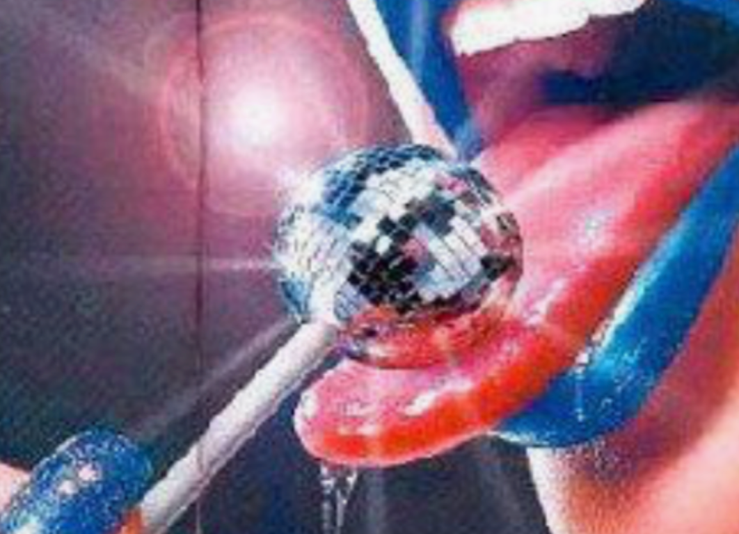 woman licking glitter ball lolipop