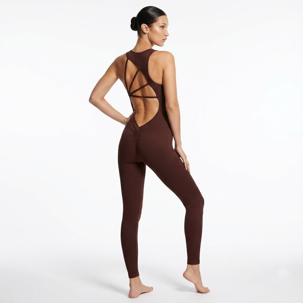 Woman wearing a brown open-back jumpsuit on a white background