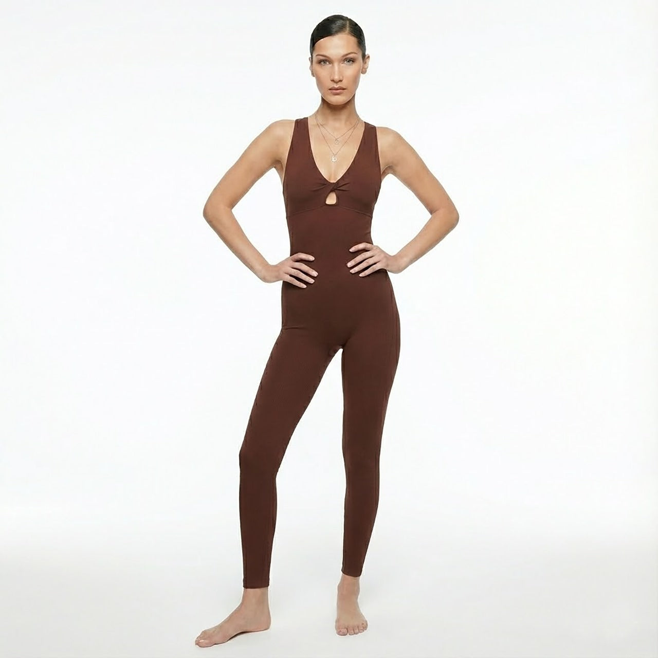 Woman wearing a brown jumpsuit on a white background