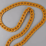 Yellow chain necklace on a gray background