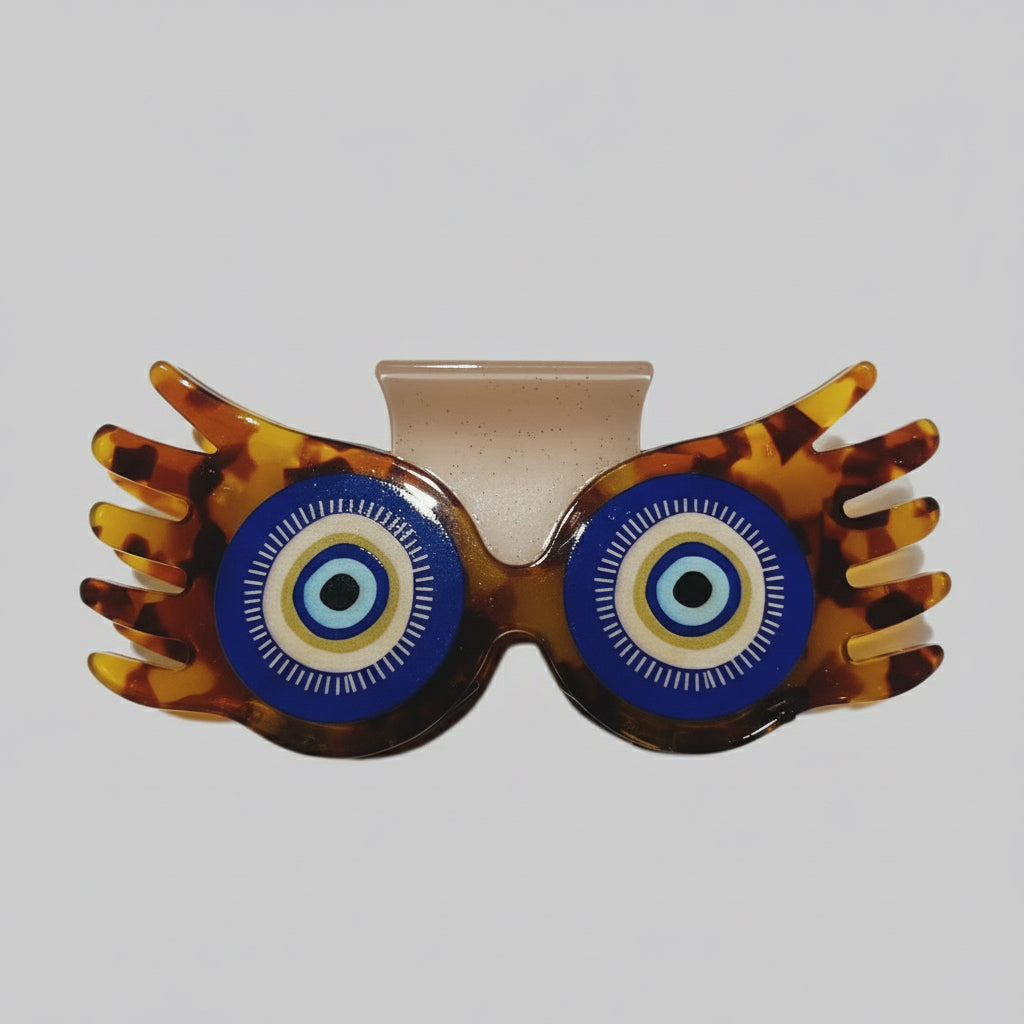 Sunglasses with tortoiseshell frame and blue lenses on a white background