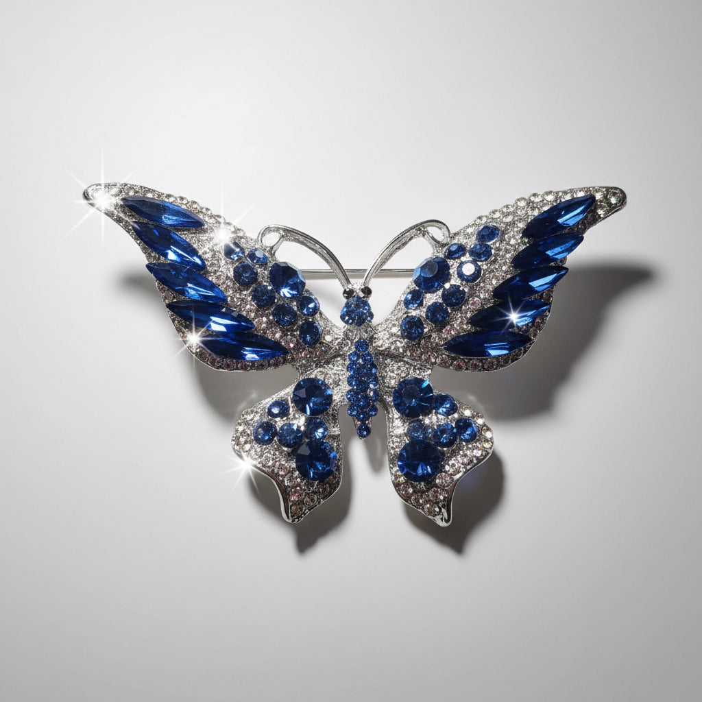 Butterfly-shaped brooch with blue gemstones on a gray background