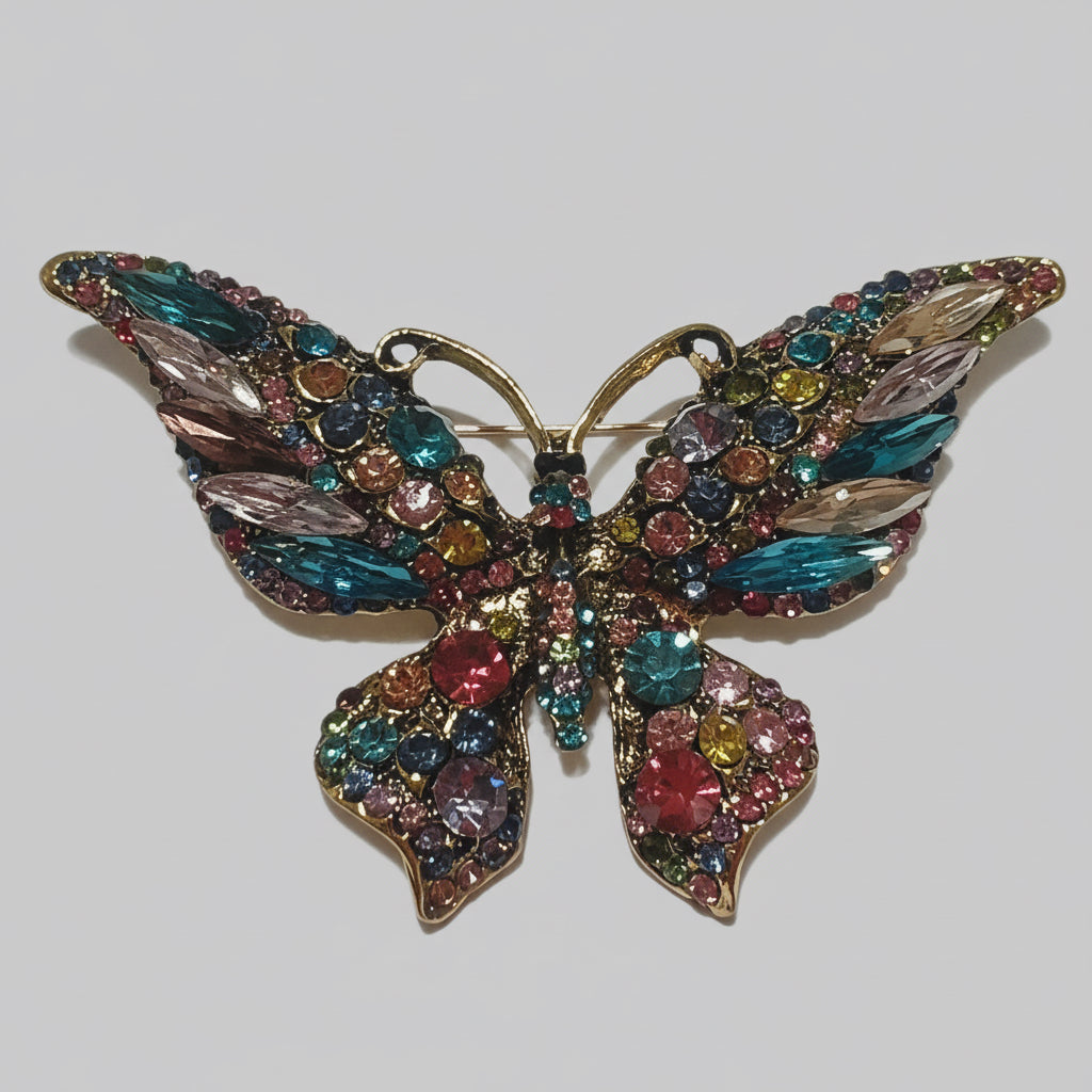 Multicolored butterfly brooch with gemstones on a gray background