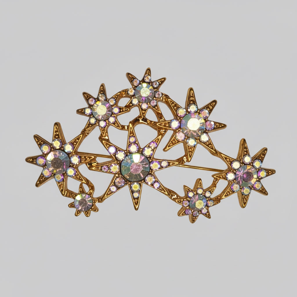Star-shaped brooch with gemstones on a light gray background