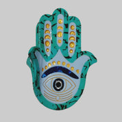 Decorative Hamsa hand with eye design on a gray background