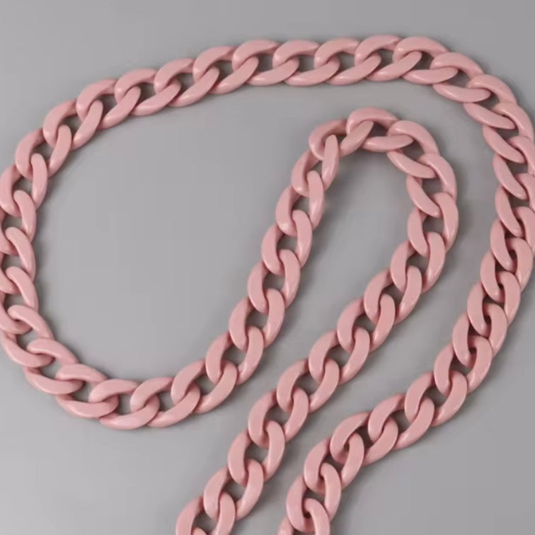 Pink chain necklace on a gray background
