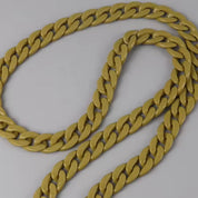 Gold chain on a light gray background