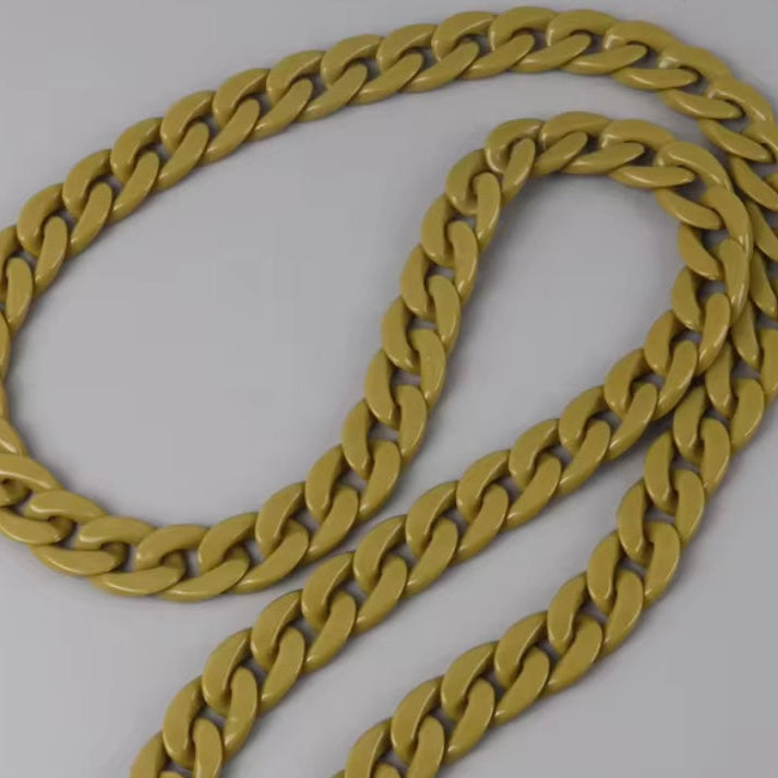 Gold chain on a light gray background
