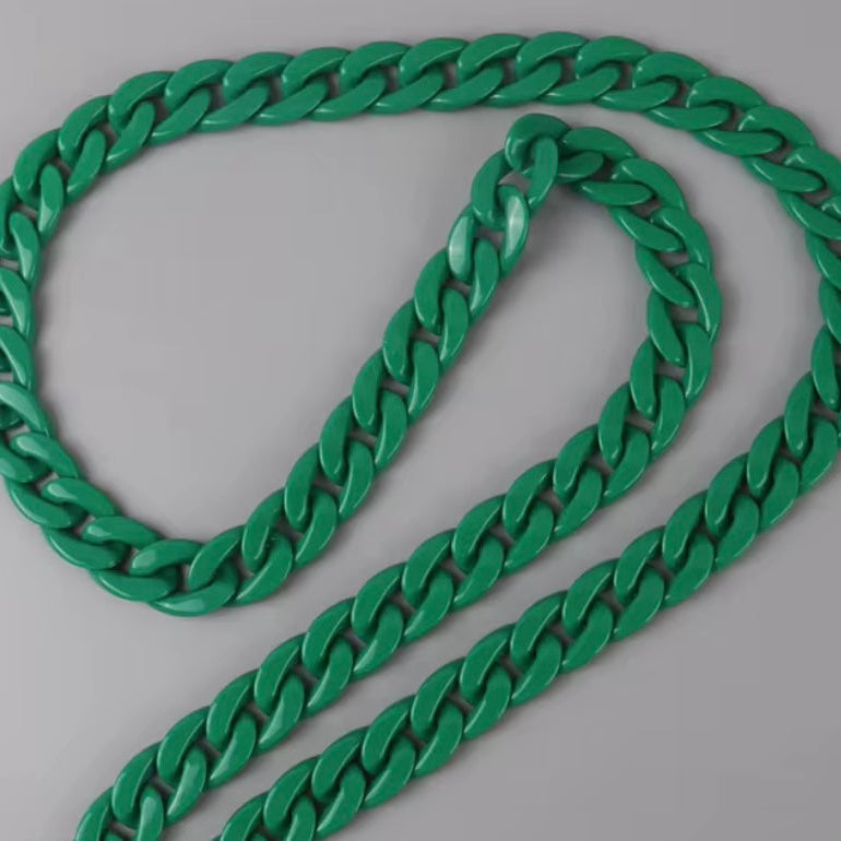 Green chain necklace on a gray background
