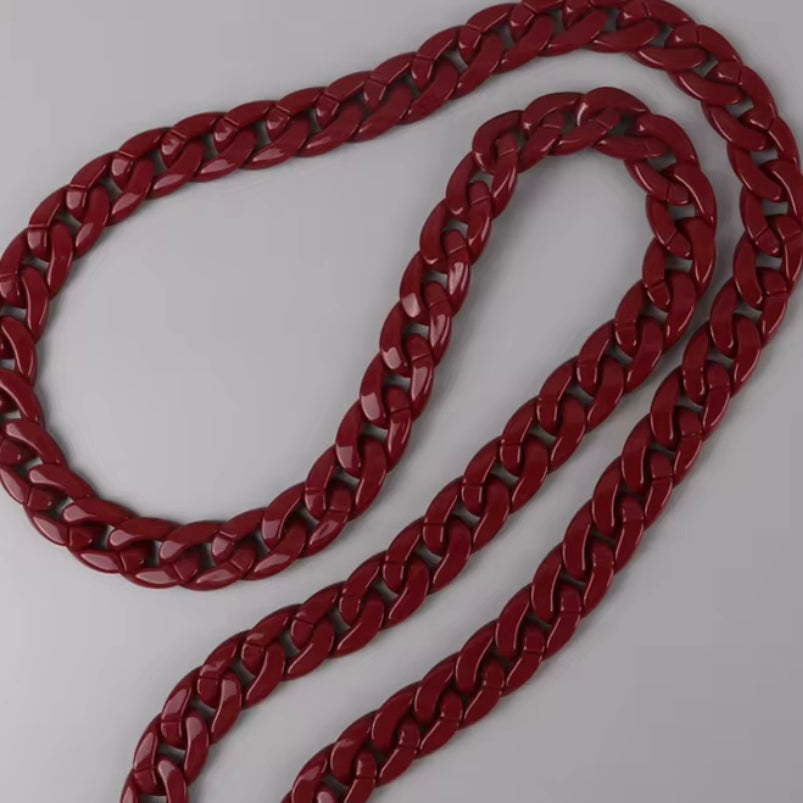 Red chain phone lanyard on a light gray background