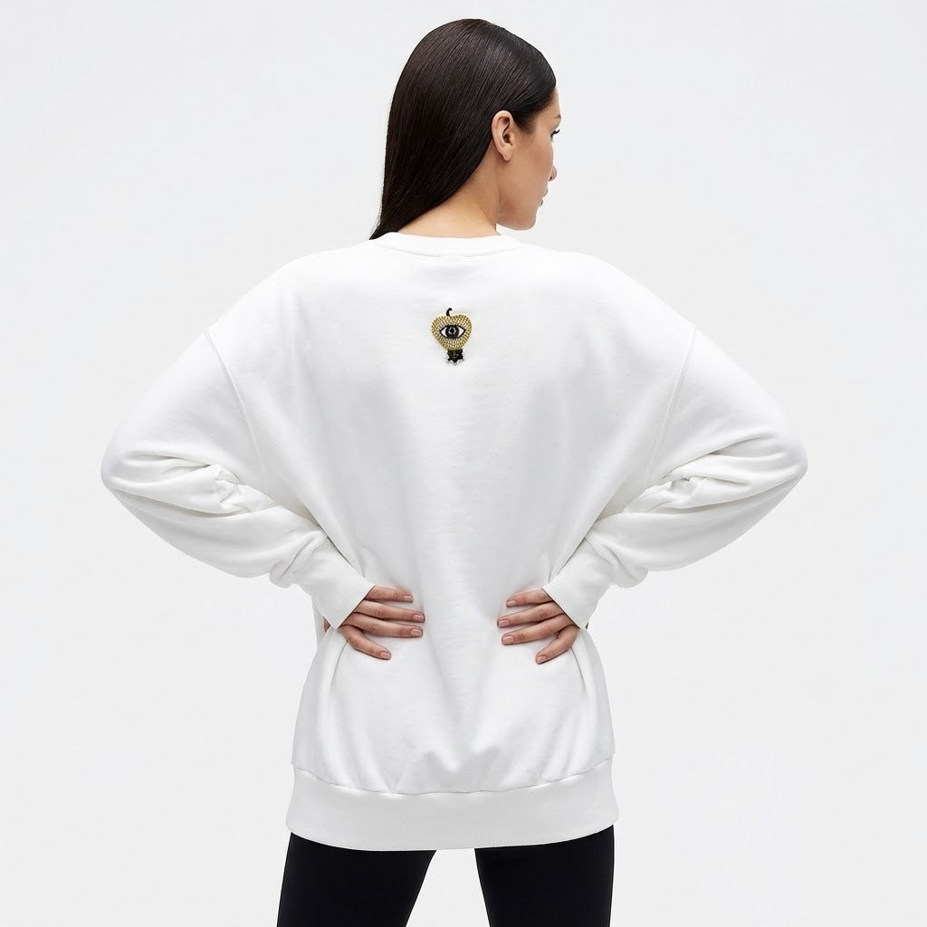 Woman wearing long sleeve oversized sweat with all seeing eye motif