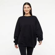 Woman wearing oversized sweat with all seeing eye motif in black front view 