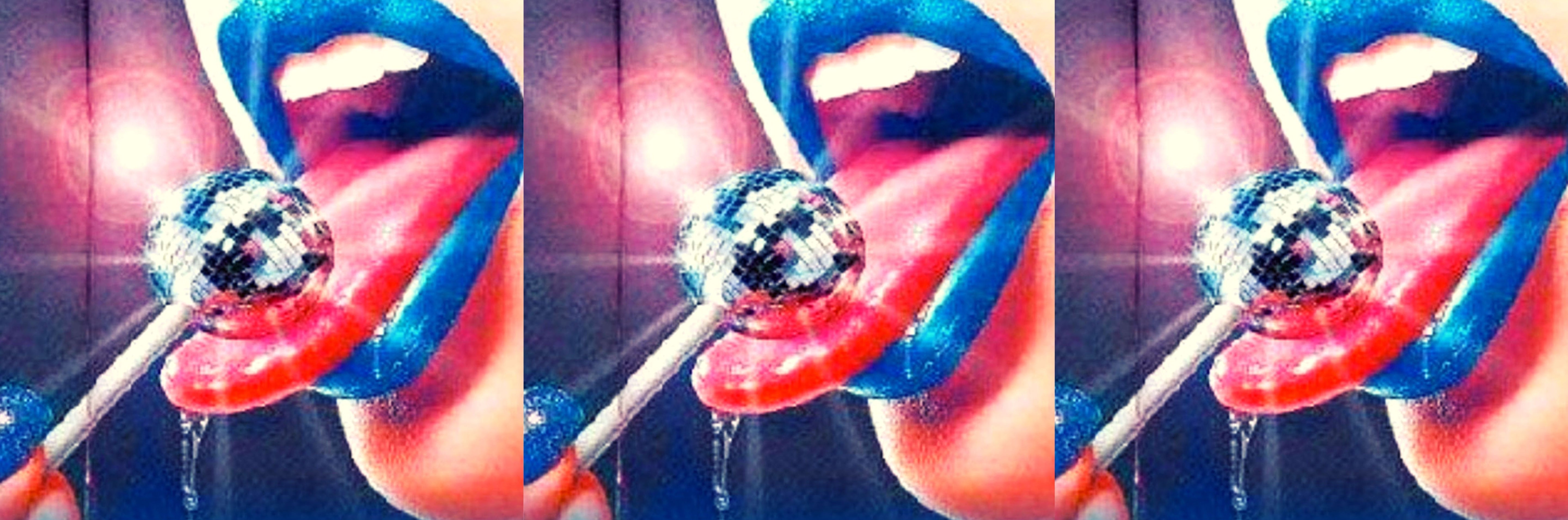 woman with blue lipstick licking glitterball lolipop