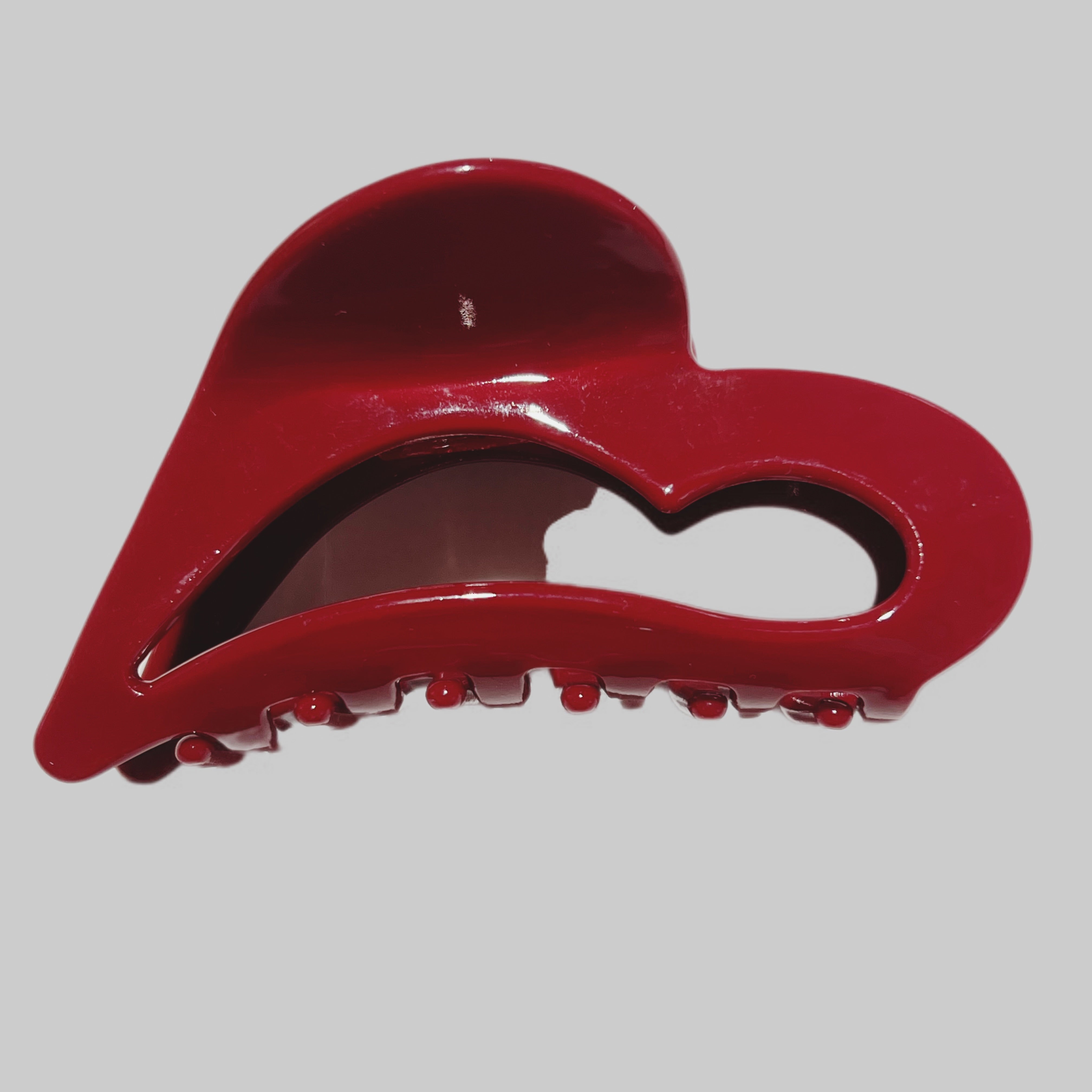 Red hair clip on a gray background