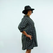 woman wearing hat in Sara - Monochrome Linear Print Skater Style Shirt Dress